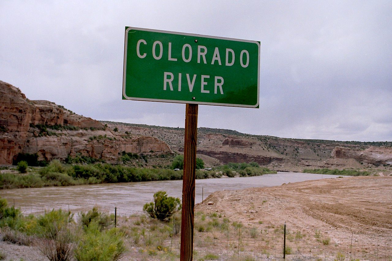Colorado River flowing behind a sign