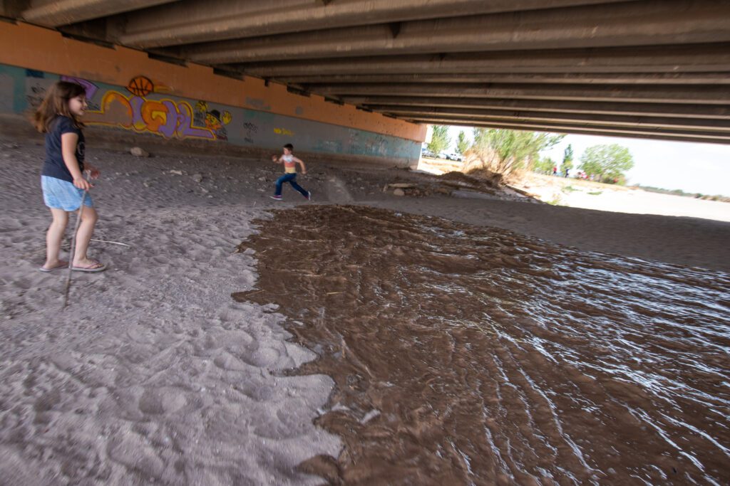 Children play in the Rio Grande
