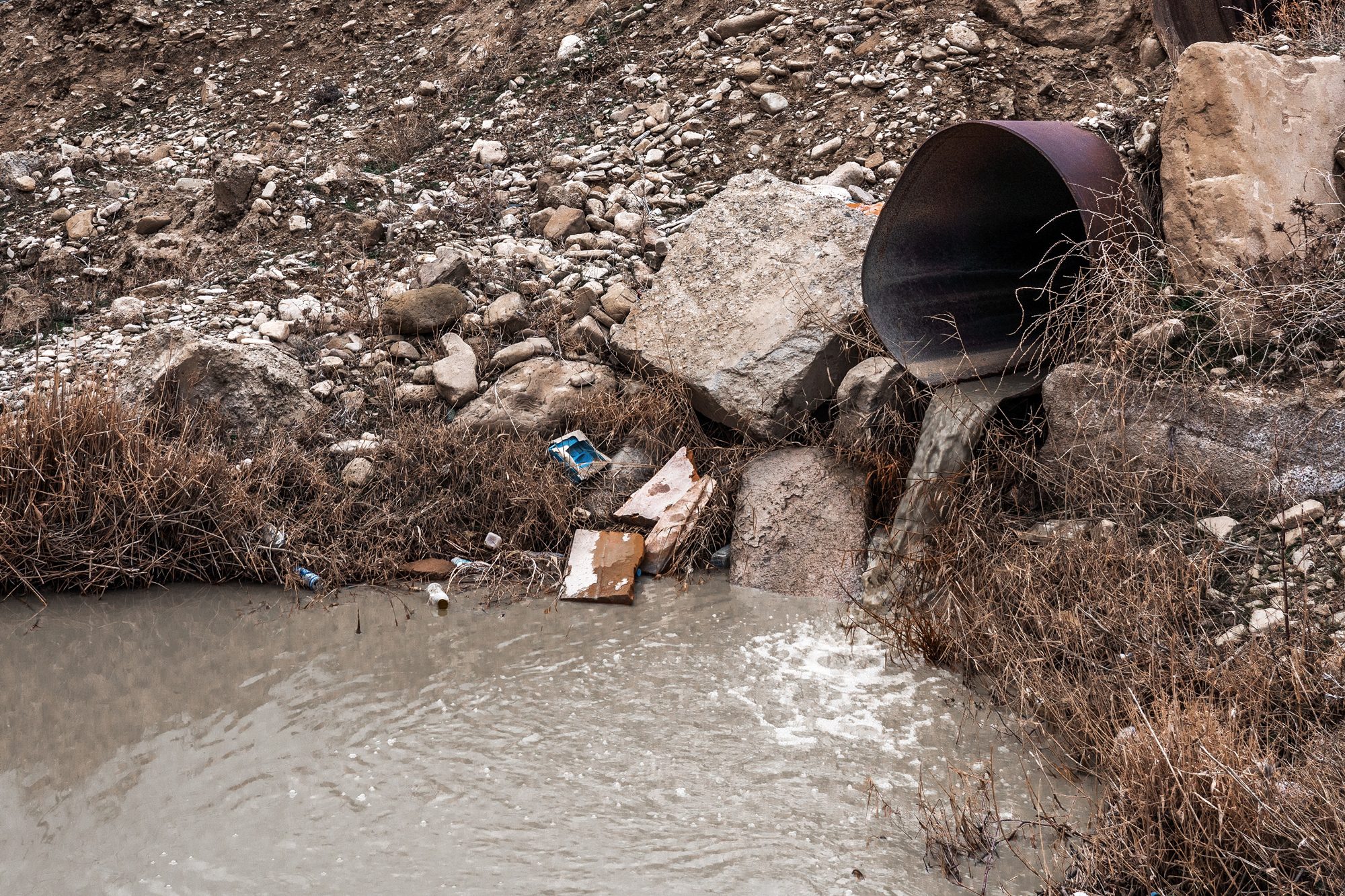 Licensed photo of sewage flowing into water to depict the Tijuana sewage crisis