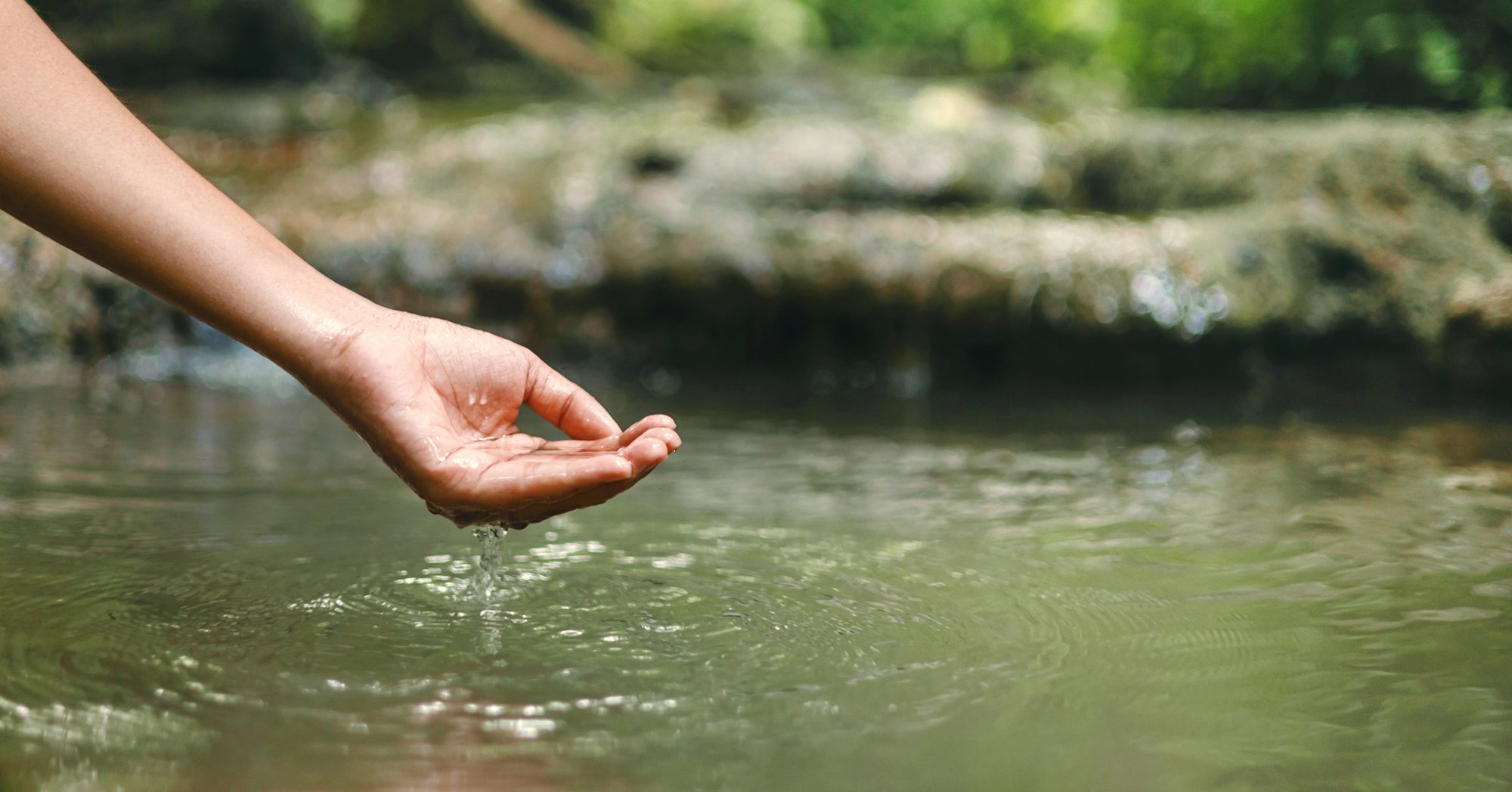 Hand reaching into water, depicting access to water (licensed content)
