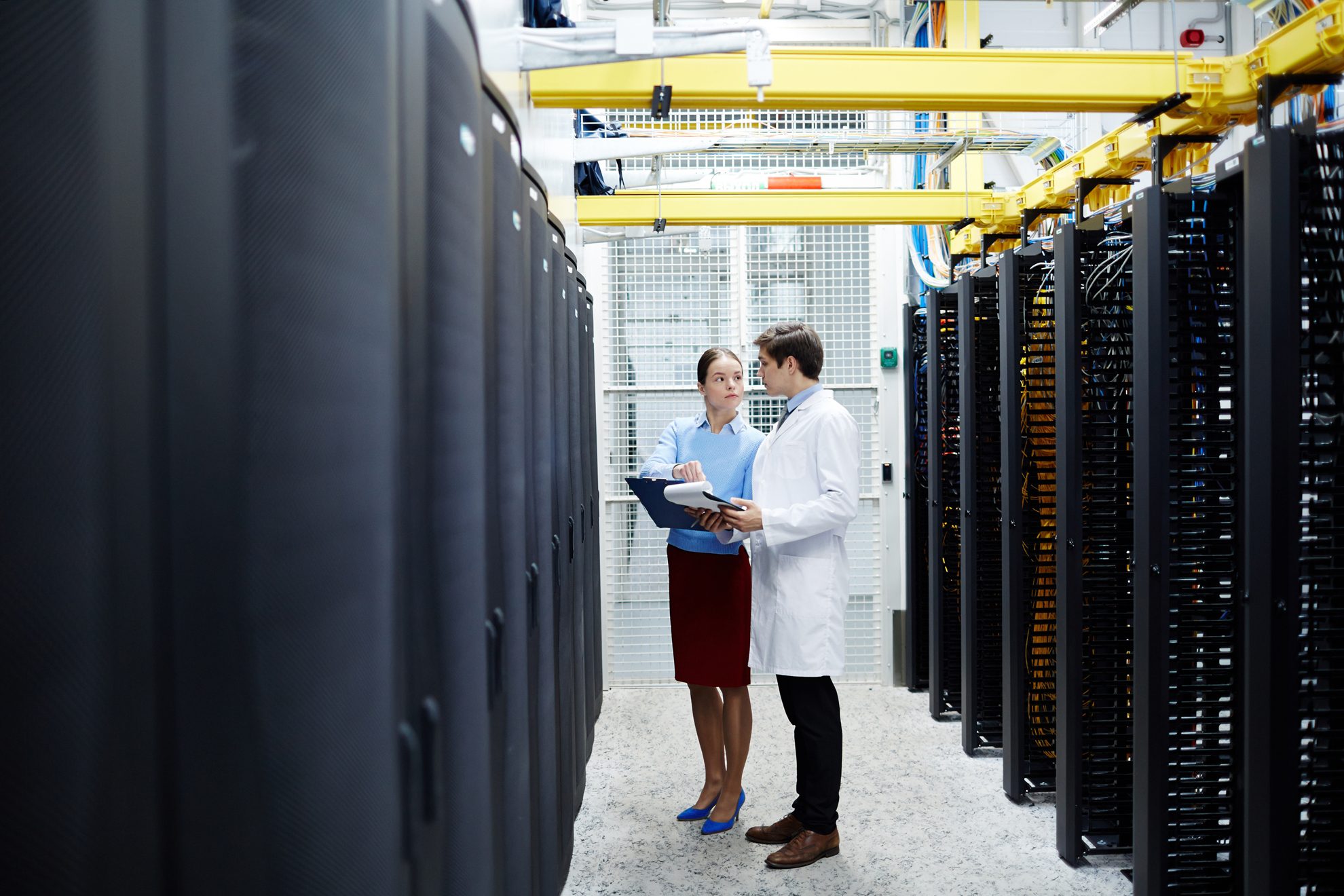 Engineers inspect hardware at a data center. Utah legislators seek transparency about data center water use.