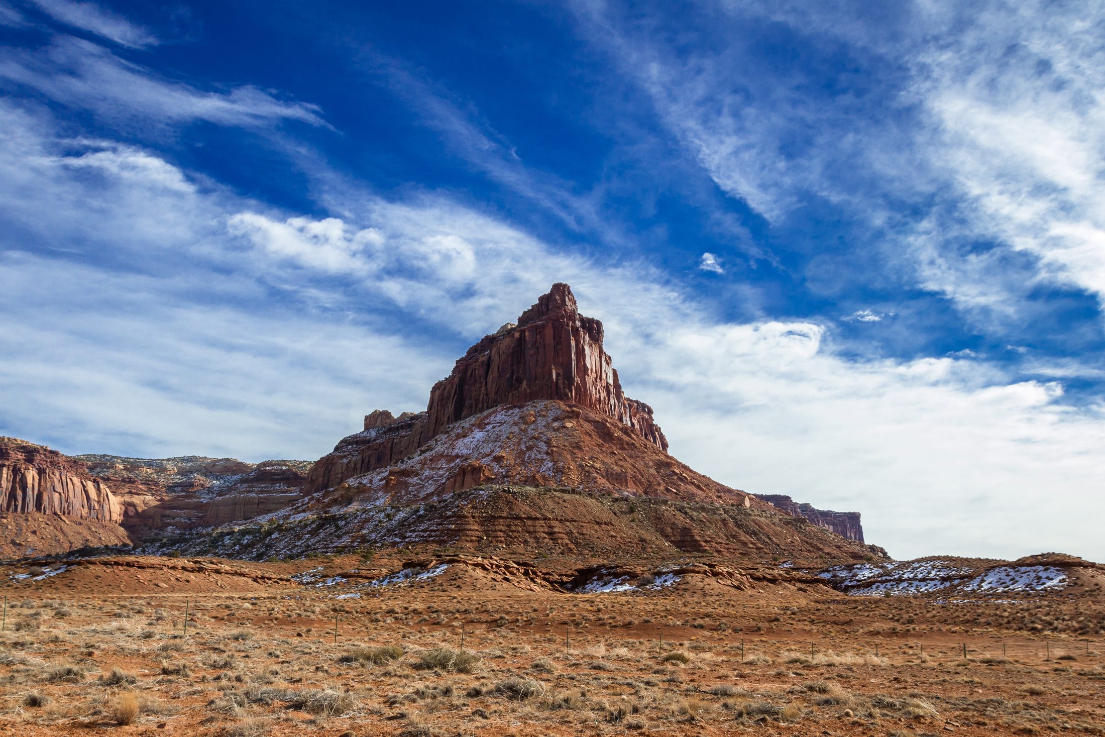 A red rock in Utah with little snow