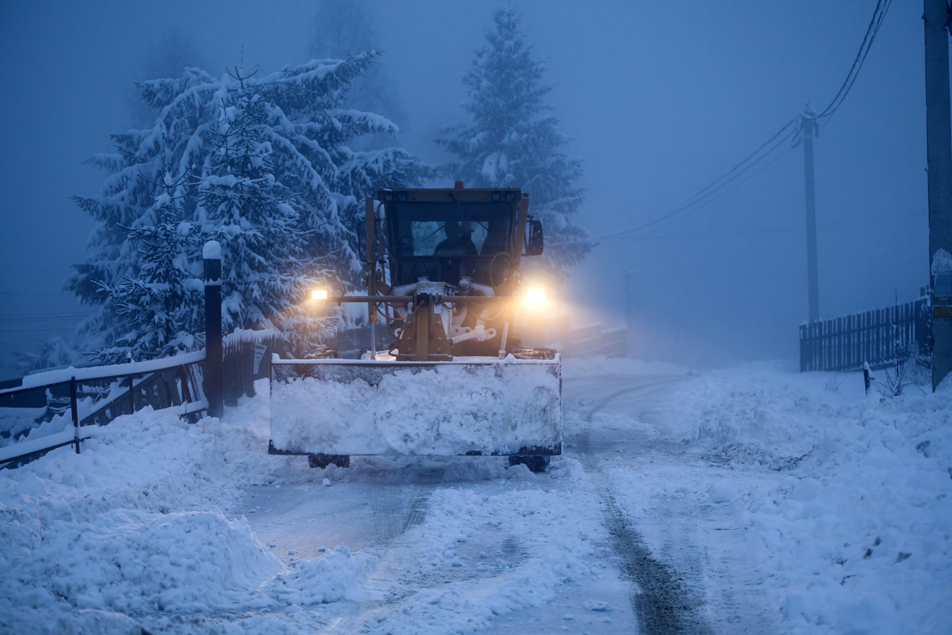 A truck clearing road during snow blizzard